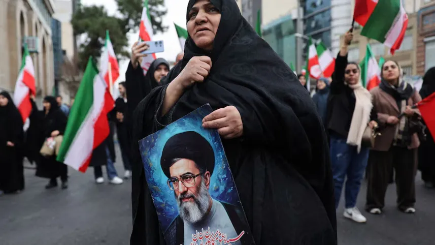 A woman holds an image of Iran’s Former Supreme Leader Ayatollah Ali Khamenei when protesting against US-Israel strikes on February 28 in Tehran. PHOTO: REUTERS